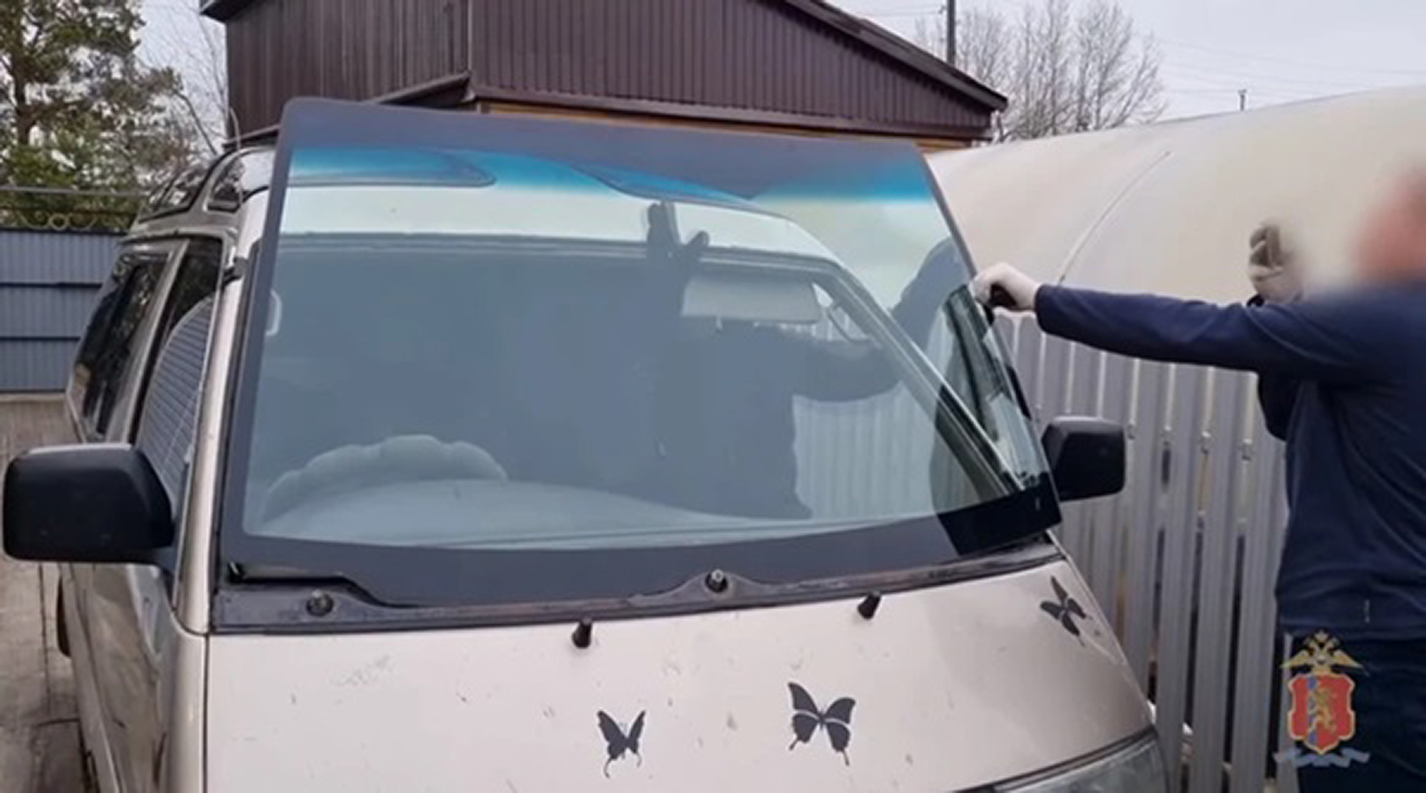 Picture shows the minibus with folding window, undated. Father and son cleaned out trucks on the Siberia highway while they were moving, like in the movie Fast and Furious. Note: Police photo. minibus with folding window
