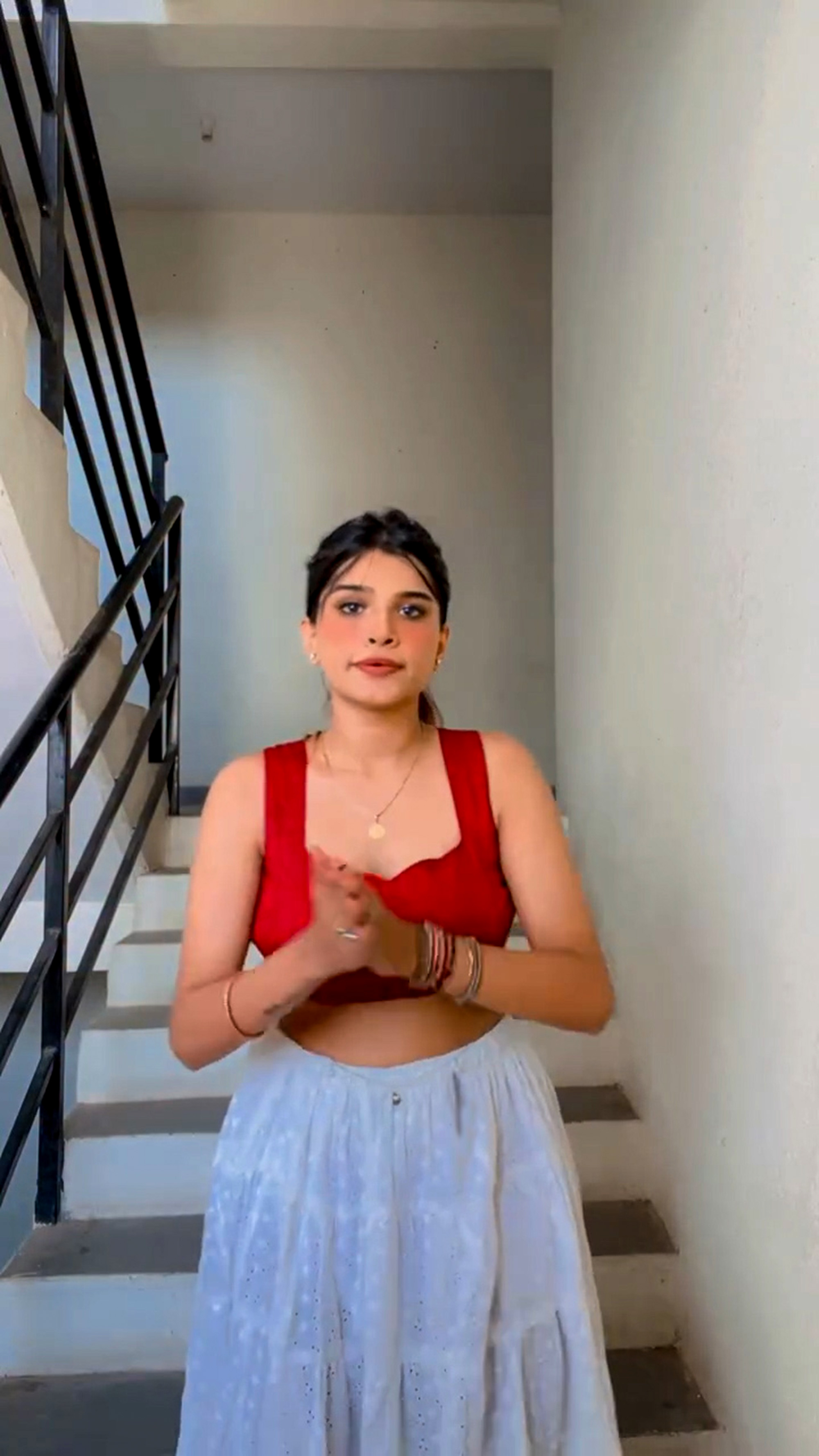 Influencer slaps man for touching her while she was filming reels on building stairs, undated. Note: Photo is a screenshot from a video. Influencer slaps man