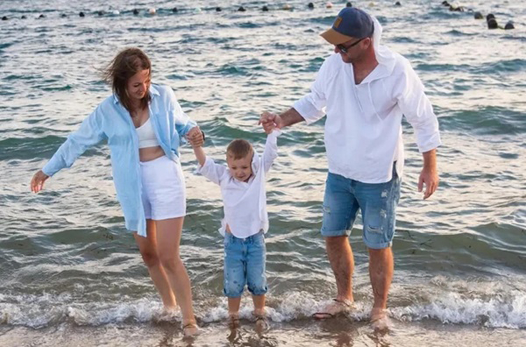 Olga Guzikova, 34, poses with husband and son in undated photo. Doctors broke her baby's shoulder during childbirth and it later died in Blagoveshchensk, Russia. Note: Private photo taken from local media. Olga Guzikova, 34, poses with husband and son
