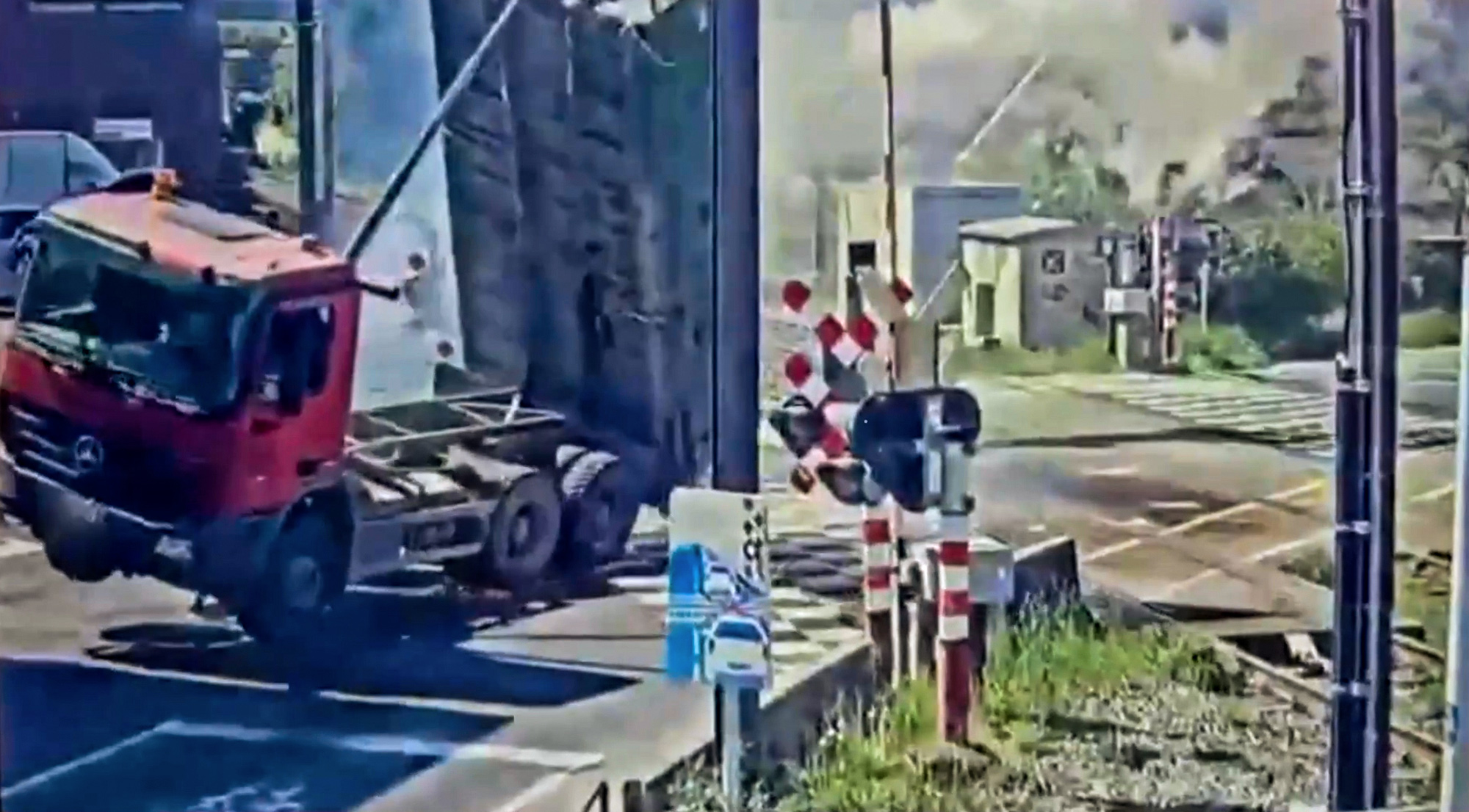 Truck overturns after hitting overhead wires at railway in Groot-Bijgaarden, Belgium, April 30, 2025. The driver had left the loading platform up. Note: Photo is a screenshot from a video. Truck overturns