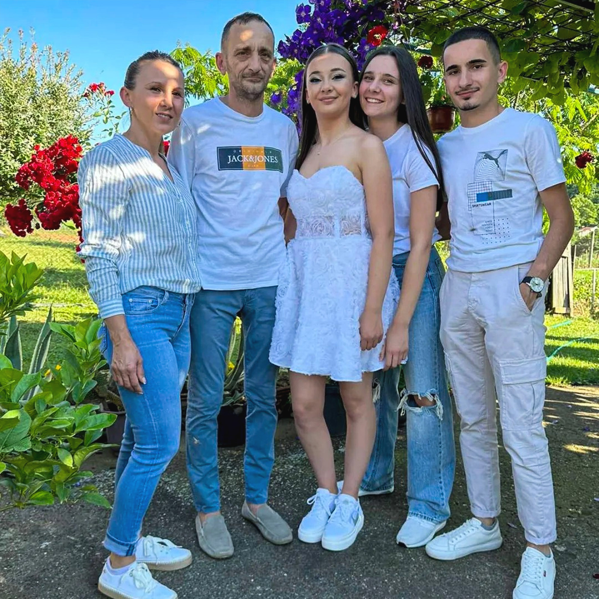 Olivera Jokic (far left), her husband Nikola Jokic (second left) and their son Filip Jokic (far right) pose with two girls