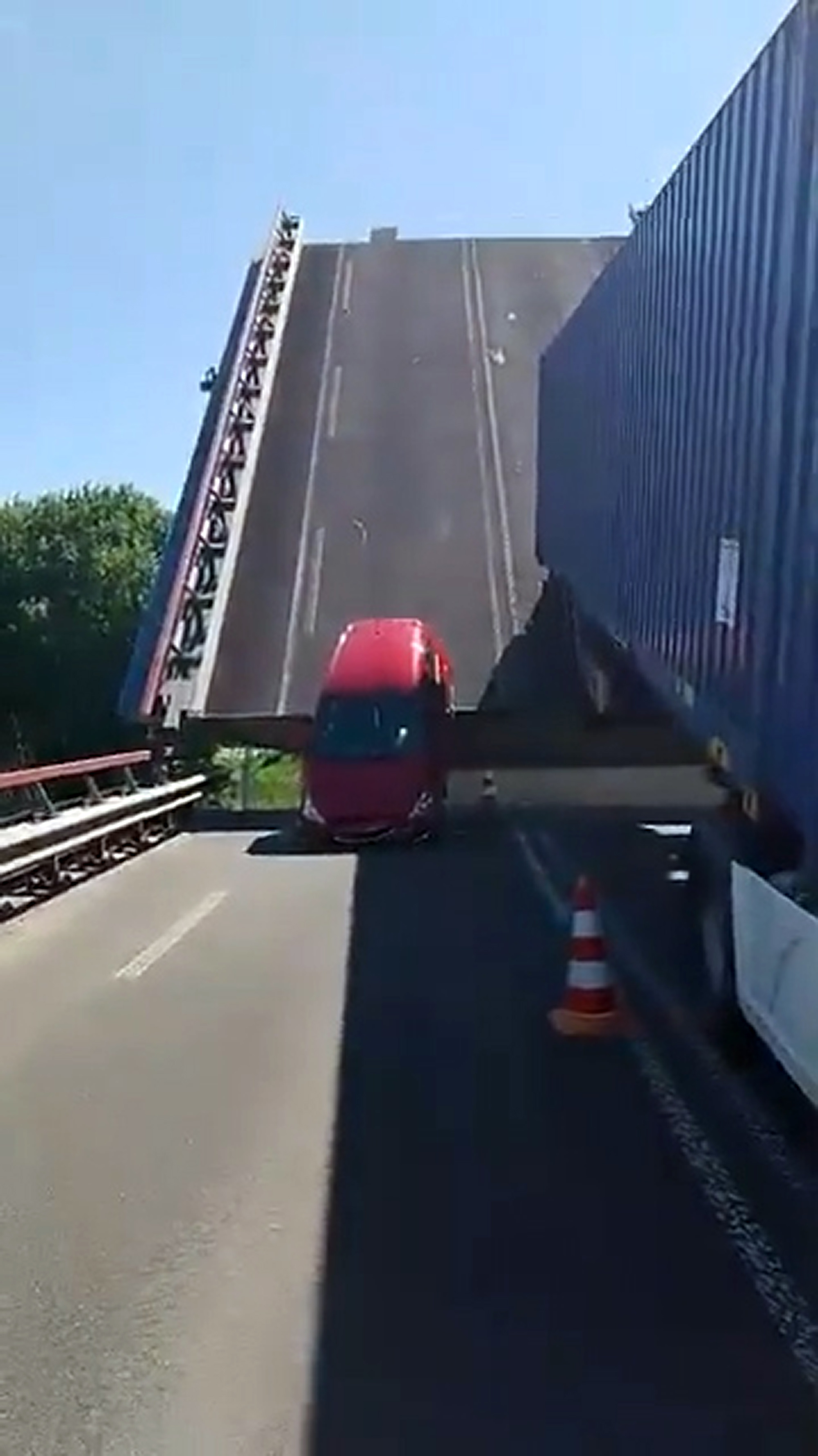 A car and a lorry stand stuck on a bridge in Lemmer, the Netherlands, on May 20, 2025. Reports said no one was injured. Note: Photo is a screenshot from a video. A car and a lorry stand stuck on a bridge in Lemmer