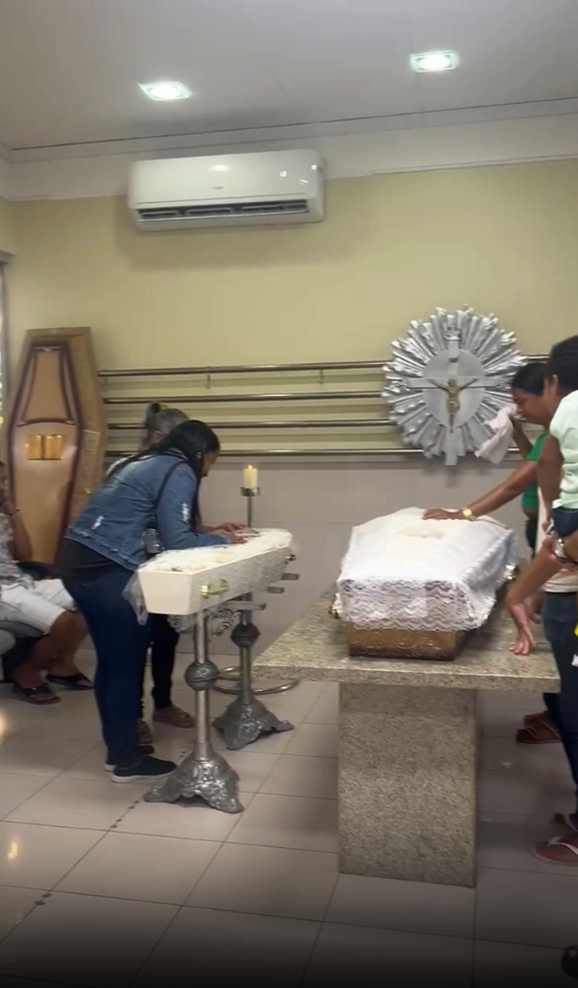 Picture shows the coffins of Hillary Janiele Vicente da Silva and her mother Iara Vicente da Silva, undated. They were killed in Maceio, Brazil, on May 25, 2025. Note: Image is a screenshot from video. Hillary Janiele Vicente da Silva