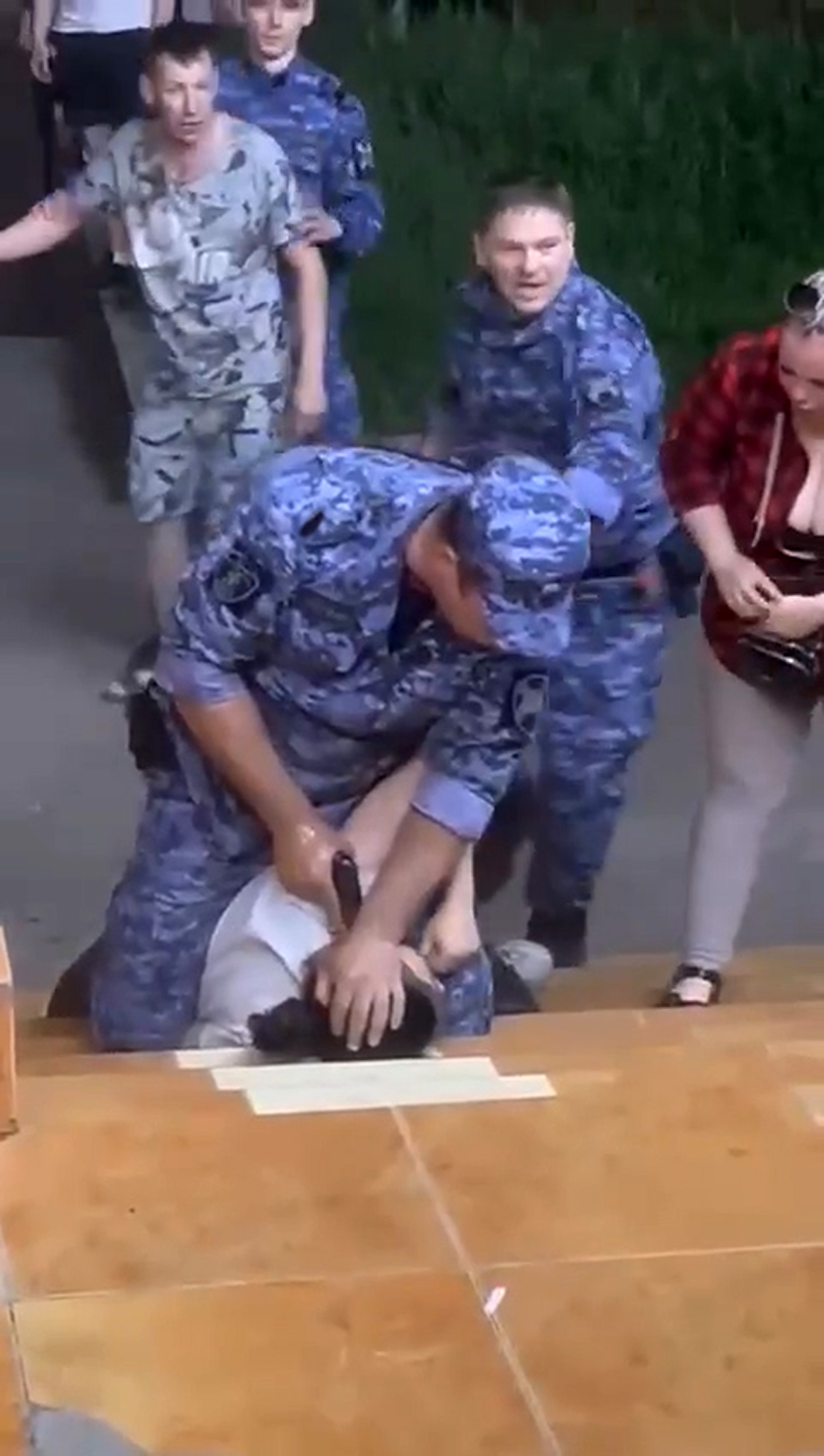 Footage shows an officer pointing a gun at a woman's head 