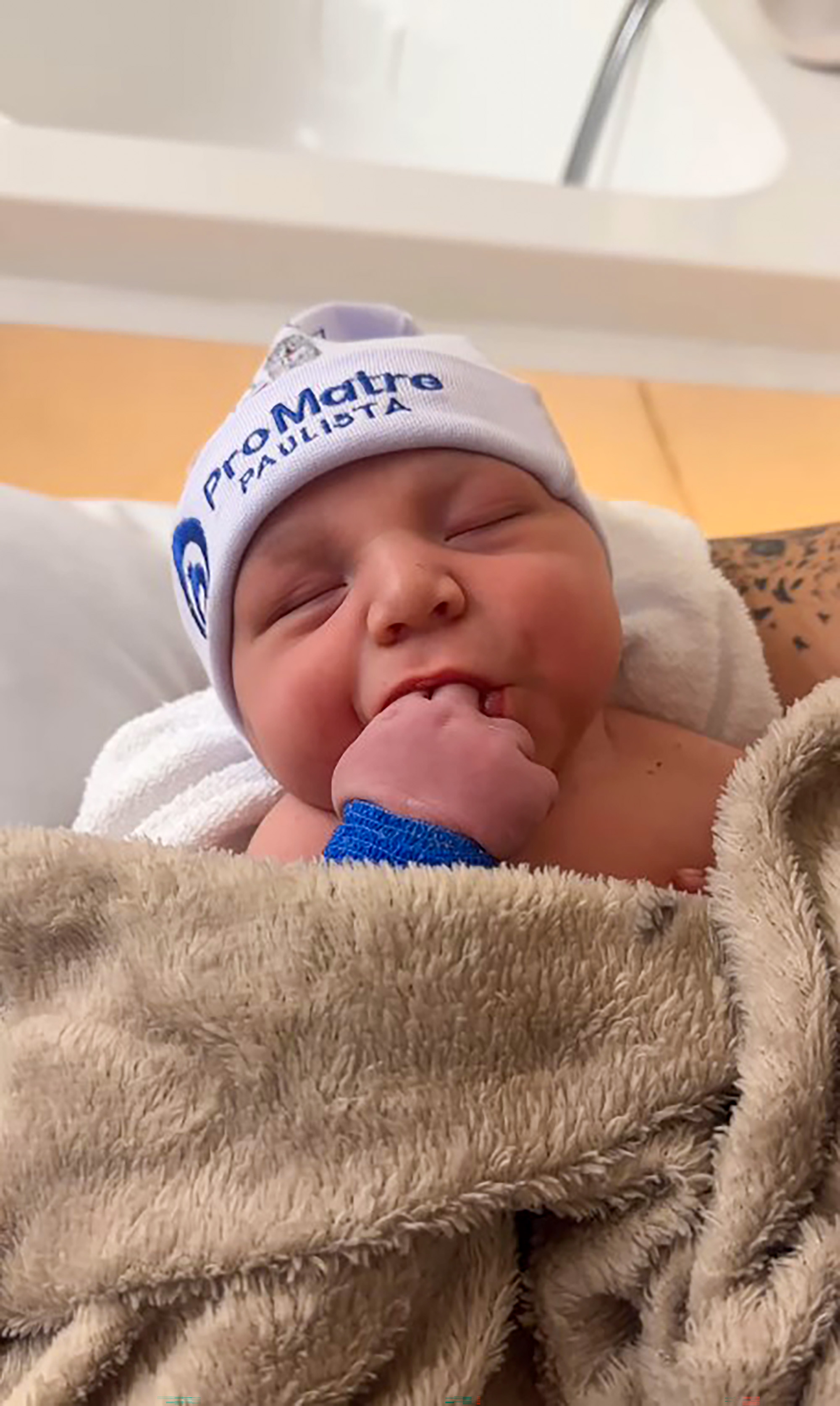 Picture shows Ravi, son of Viih Tube and Eliezer, undated. Eliezer was impressed with the size of Ravi 's foot. Note: Image is a screenshot from video. Ravi
