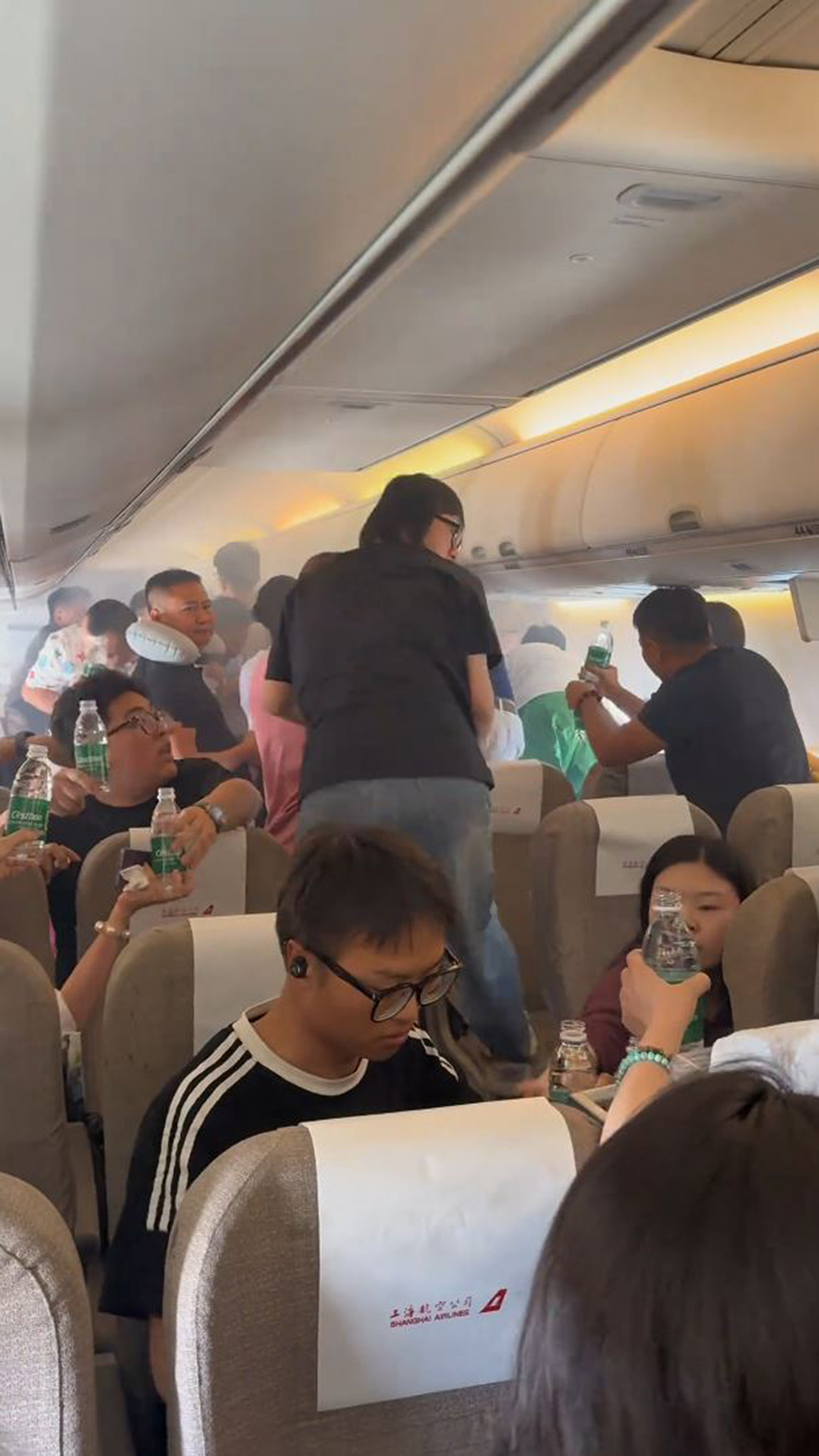 Panicked passengers try to put out fire on flight from Zhoushan to Jieyang in China, on 13 June 2025. The plane was about to land when the cabin suddenly filled with smoke. Note: Photo is a screenshot from a video Panicked passengers try to put out fire on flight from Zhoushan to Jieyang in China