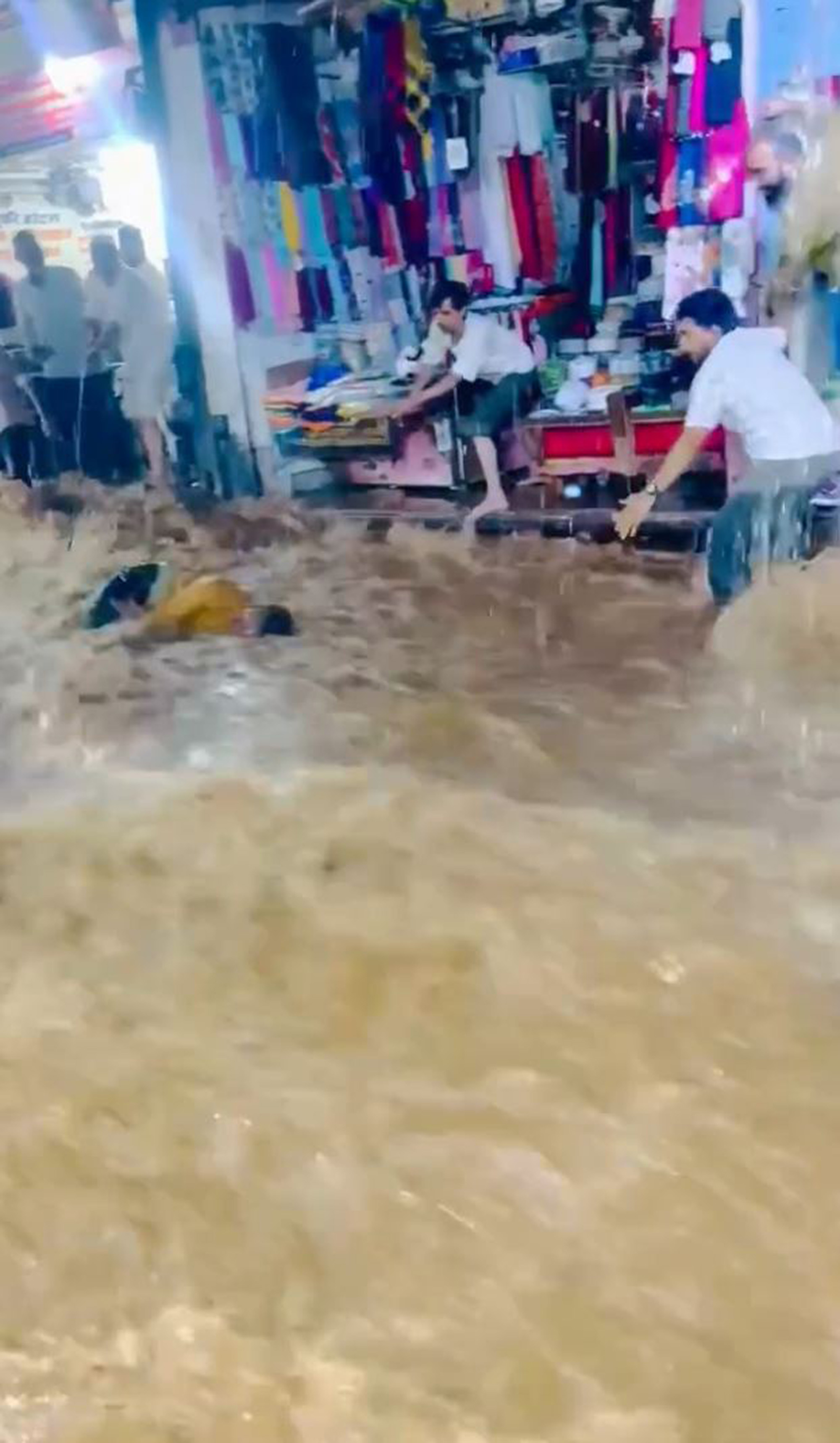 Floodwater sweeps away a man in Ajmer, India, undated. He was saved by a hotel worker. Note: Photo is a screenshot from a video Floodwater sweeps away a man in Ajmer