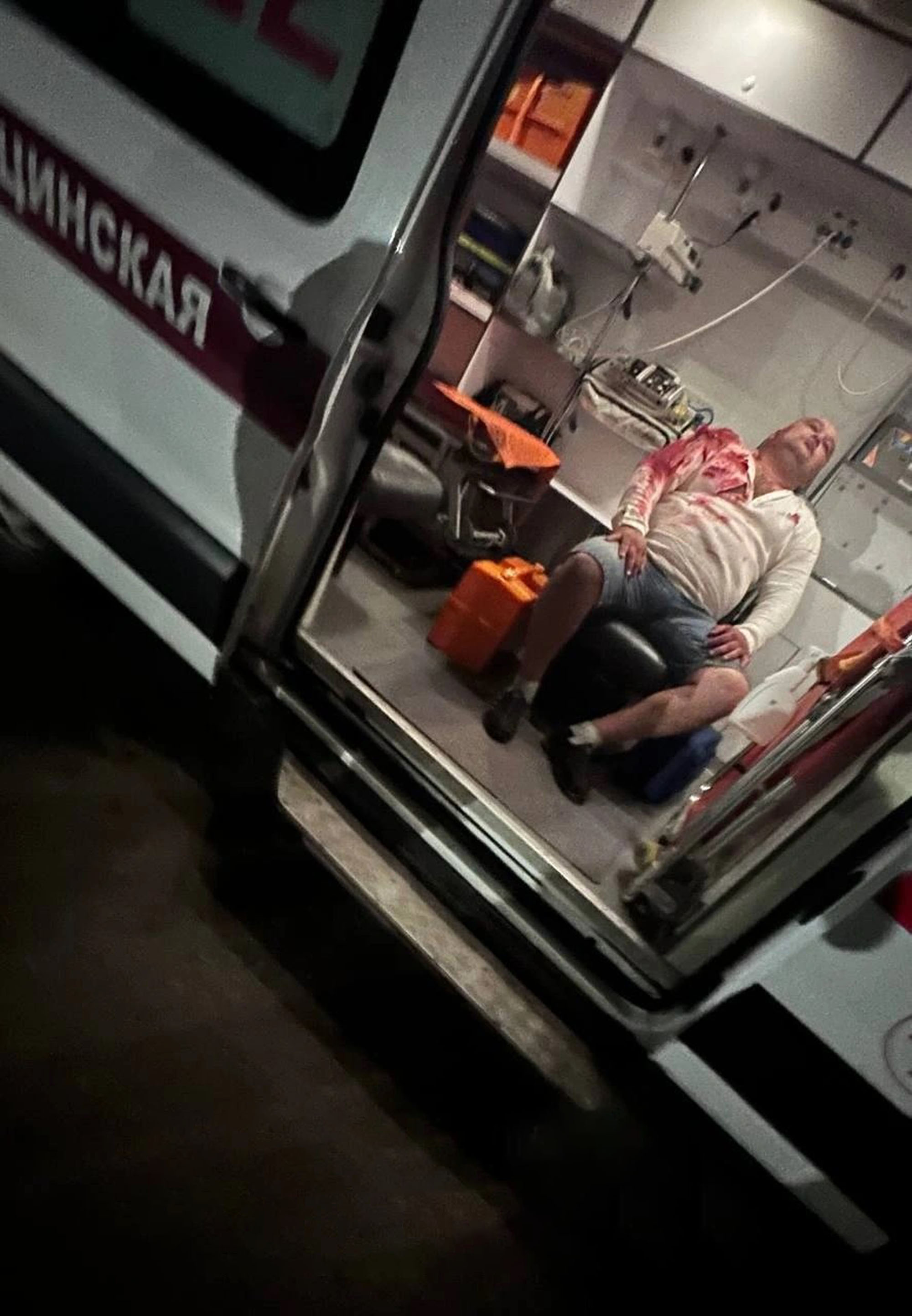 Picture shows an injured man in an ambulance