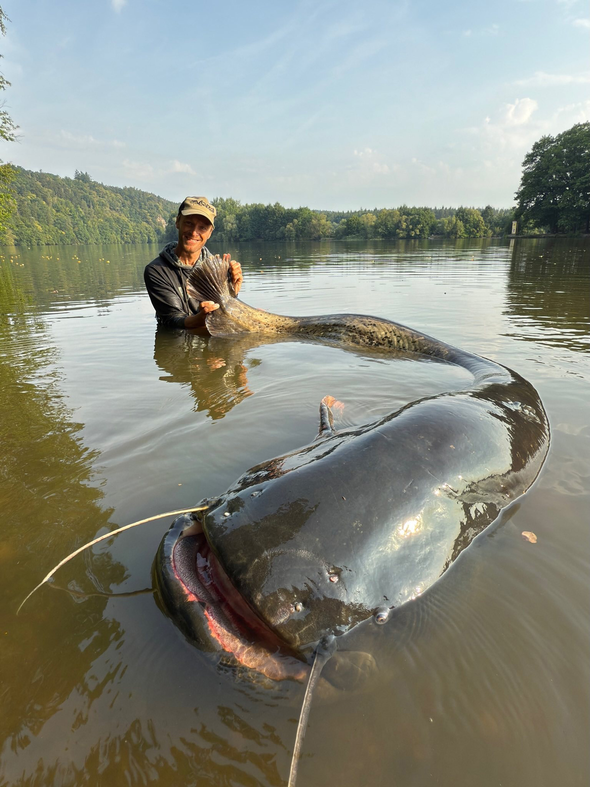 Jakub Vagner, 43, shows the 2.72-meter-long fish he caught in Czech Republic, undated. He improved his previous record of 2.68 meters from this summer. Note: Private photo taken from social media. Jakub Vagner