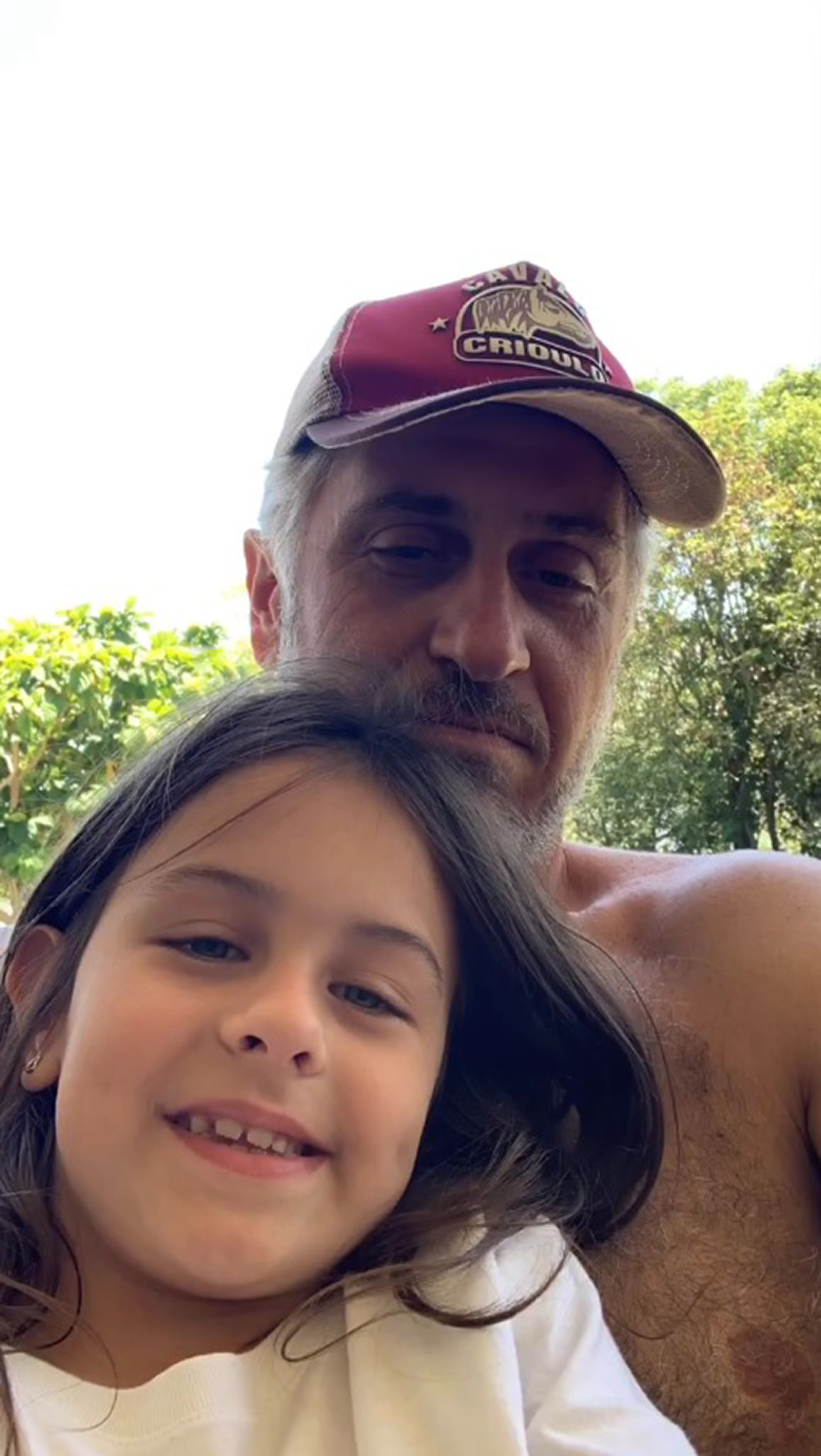 Jonas Stefanello poses wth a child 