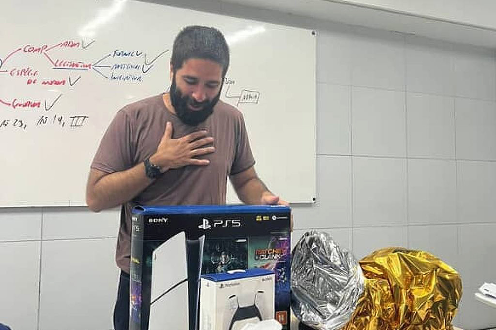 Bruno Vasconcelos poses with PlayStation 5, undated. He received it as gift from students in Recife, Brazil. Note: Private photo. Bruno Vasconcelos