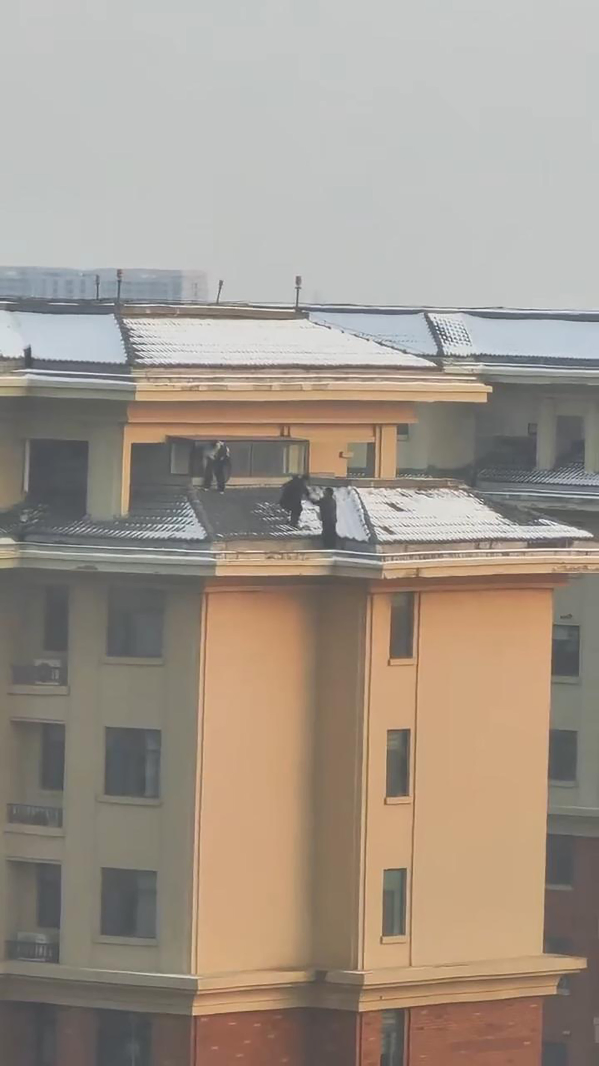 Video shows children on snow covered rooftop of a residential building in Xinxiang, China, Jan. 21, 2026. Note: Photo is a screenshot from a video. Video shows children on snow covered rooftop of a residential building in Xinxiang, China, Jan. 21, 2026