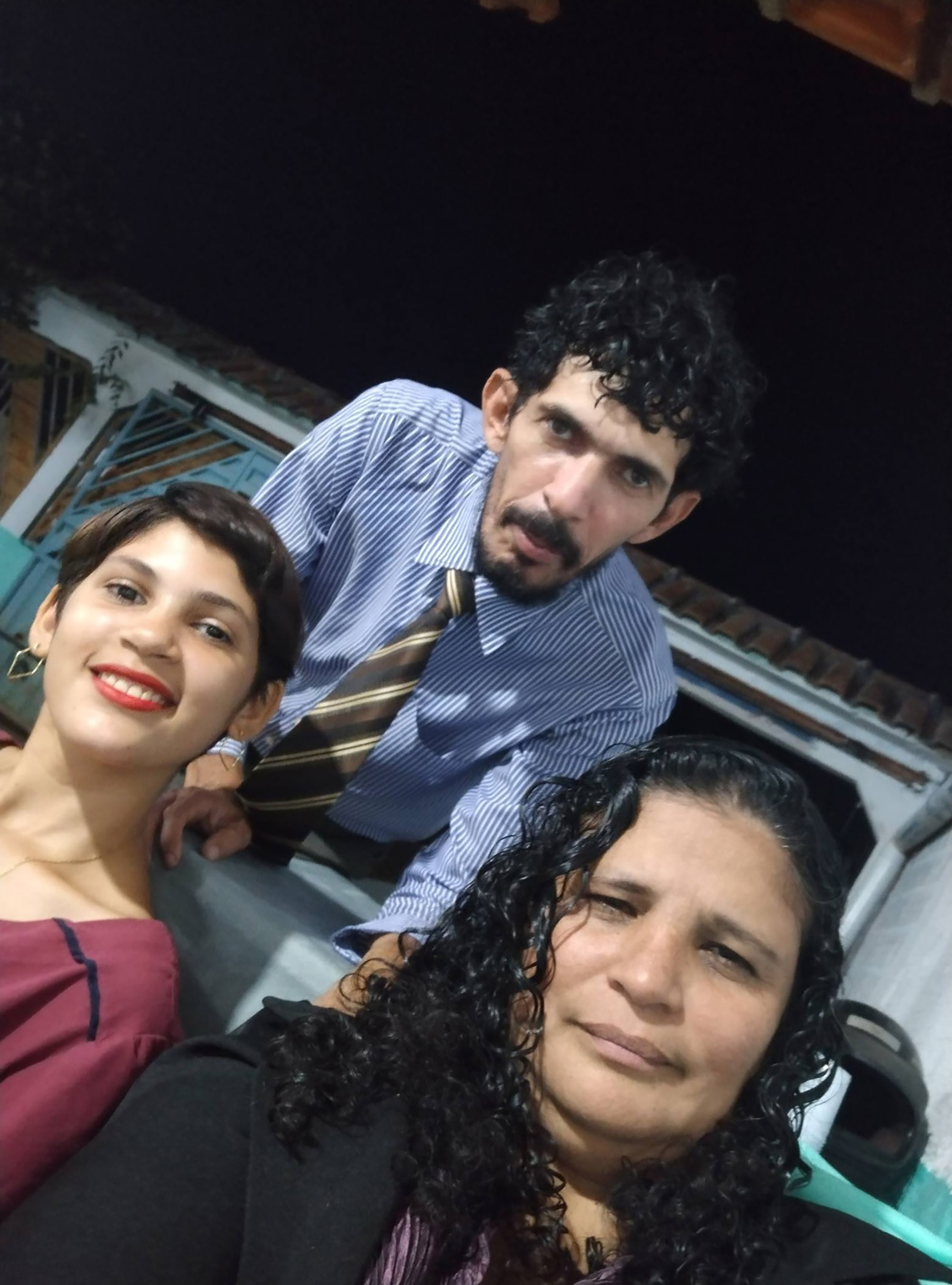 Marta Isabelle dos Santos Silva poses with her father and her stepmother