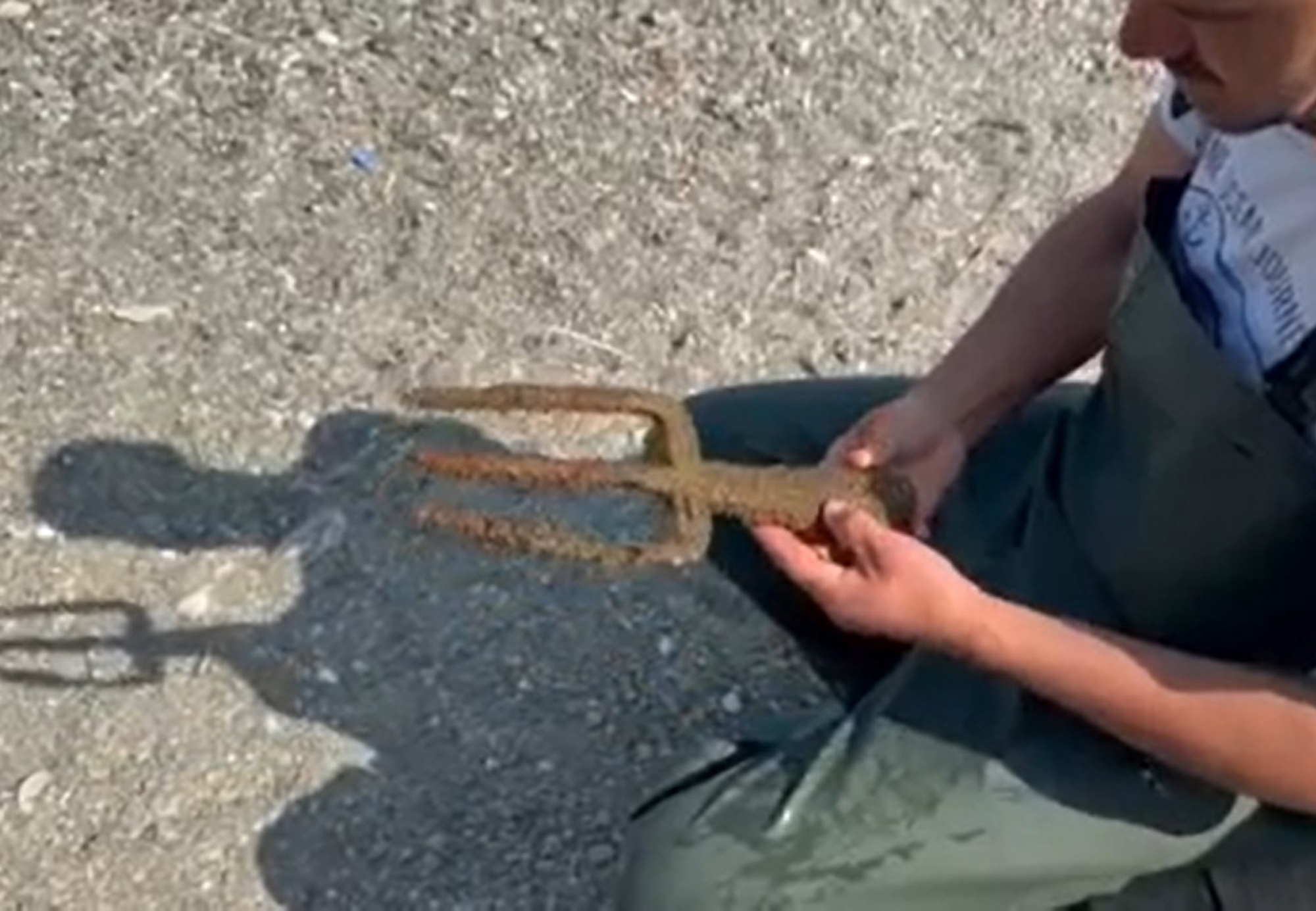 Picture shows a person holding the spearhead, known as the Poseidon Spear, undated. The item was found in a lake in Iznik, Turkey. 1747247882463-069vwu9f.jpg