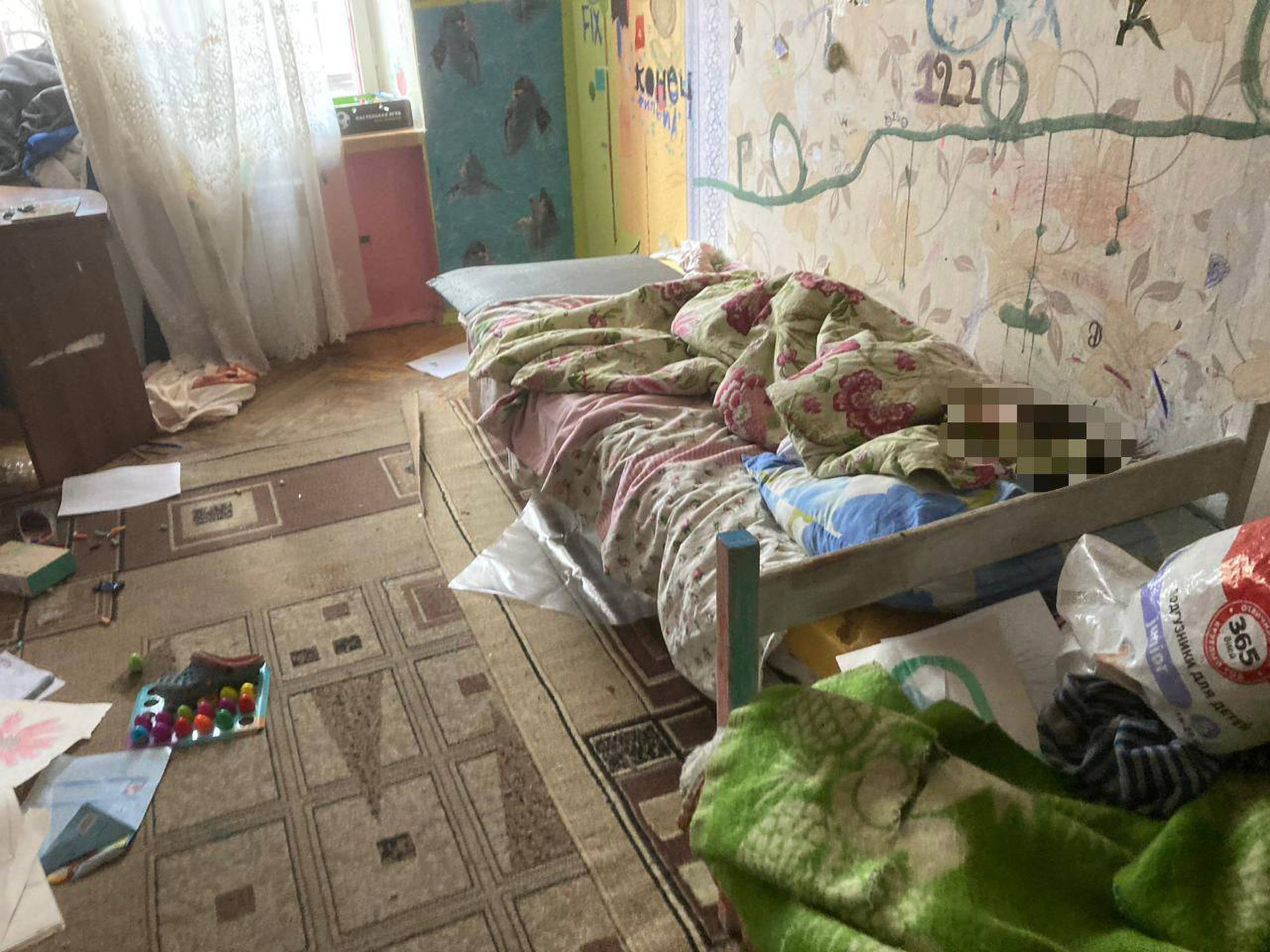An emaciated boy, 7, lays under blanket in an apartment littered with rubbish in Moscow, Russia, undated. The boy was hospitalized and handed over to the authorities. Note: Picture is from the Prosecutor's Office of Moscow. (@moscowproc/Newsflash) 1748549806505-w3fsqgct.jpg